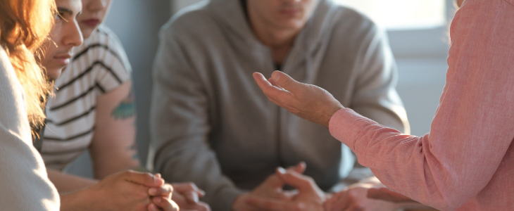 group of people sitting in circle, no faces showing